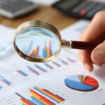 Financial reports on desk with charts and calculator